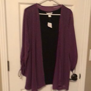 Women’s tunic blouse with flyaway attached to black tunic.